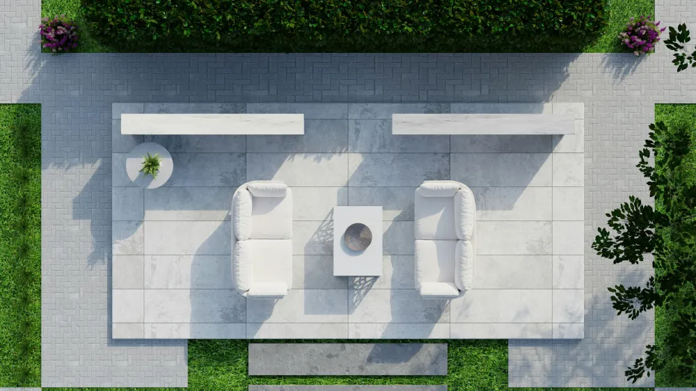 An aerial view of a modern outdoor seating area with white cushioned chairs and a sleek table on light-colored pavers, surrounded by lush grass and trimmed hedges.